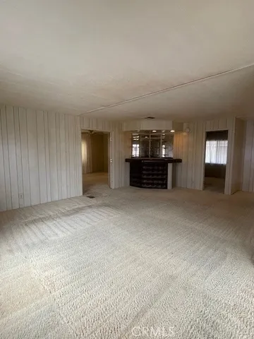a view of empty room with furniture and window