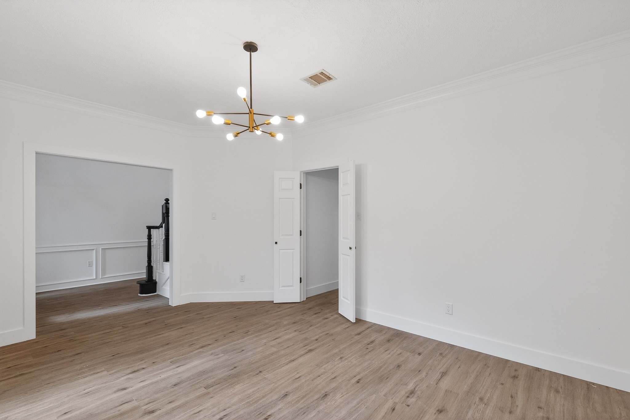 523 Rampart Lane Conroe, TX 77302 - Photo 6 of 41 Elegant dining space showcasing modern designer lighting, abundant natural light, premium flooring, and a versatile layout perfect for memorable gatherings and sophisticated entertaining.