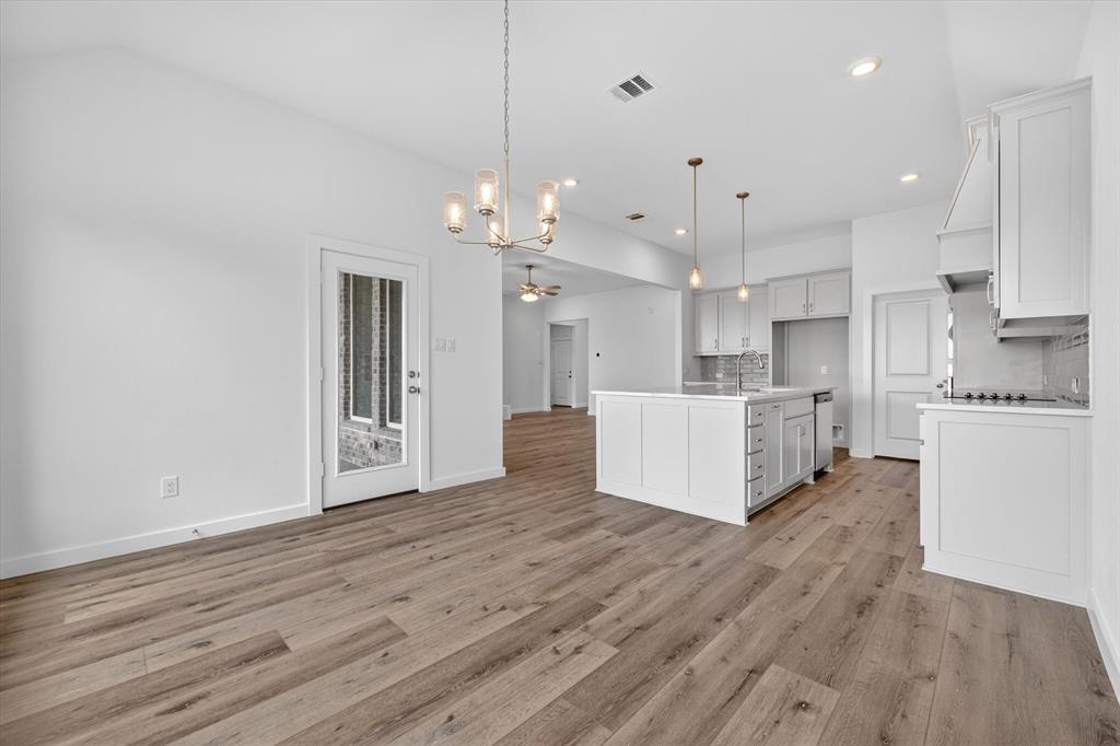 416 McAlpine Drive Springtown, TX 76082 - Photo 13 of 40 Spacious kitchen and dining area with wood-finish flooring