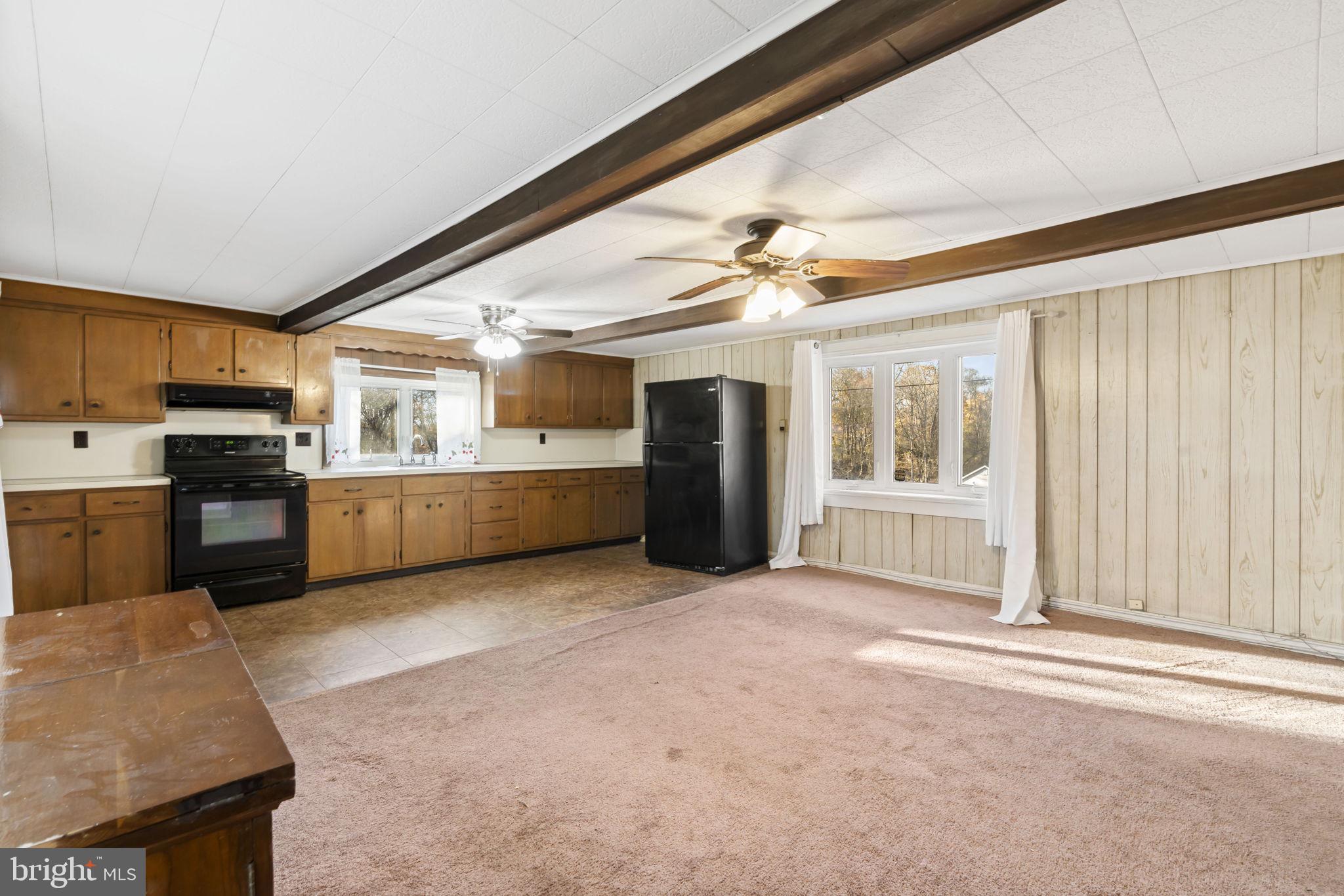 198 Glenrose Road Coatesville, PA 19320 - Photo 14 of 43 a large white kitchen with stainless steel appliances granite countertop a refrigerator and a stove top oven