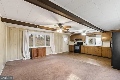 a large kitchen with a large window and stainless steel appliances