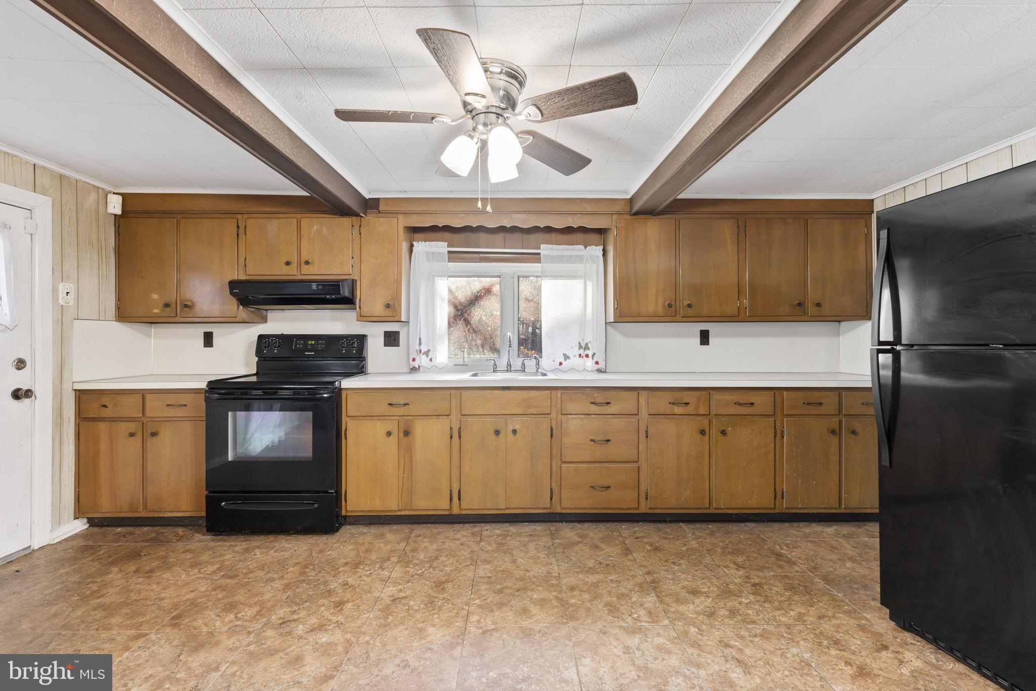 198 Glenrose Road Coatesville, PA 19320 - Photo 18 of 43 a kitchen with granite countertop a refrigerator stove top oven a sink and dishwasher