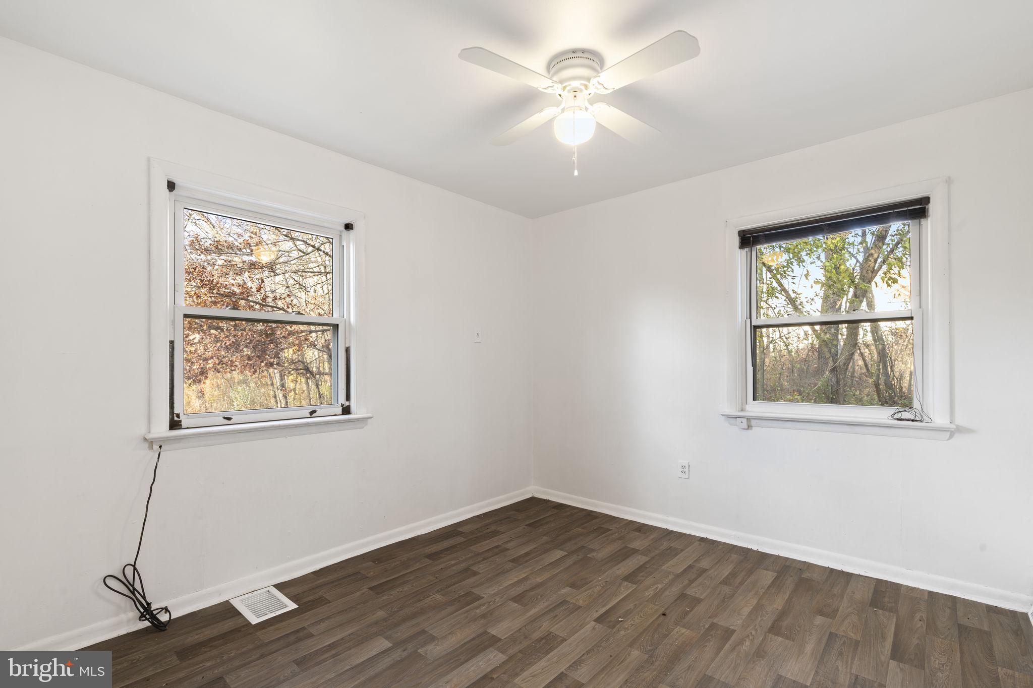 198 Glenrose Road Coatesville, PA 19320 - Photo 21 of 43 a view of an empty room with wooden floor and a window