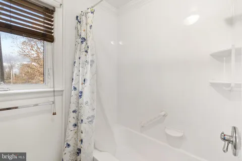 a bathroom with a bathtub and shower