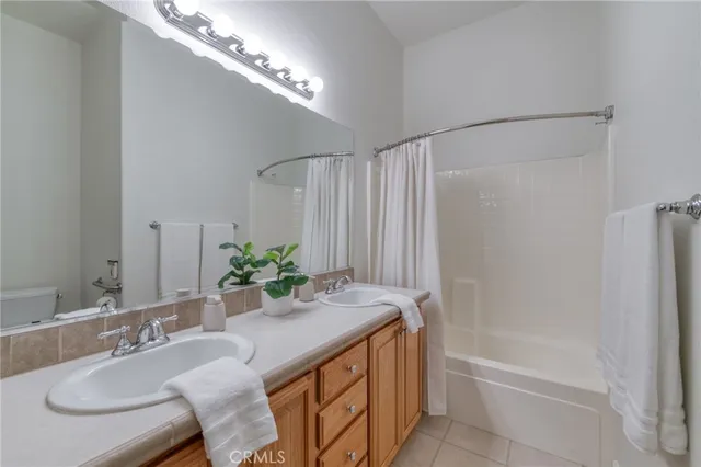 a bathroom with a granite countertop sink a mirror and a bathtub