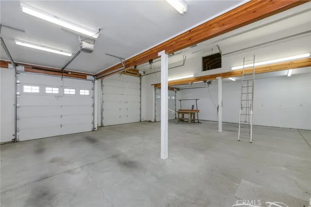 a view of a house with backyard sitting area and garden