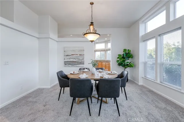 a dining room with furniture a window and a chandelier