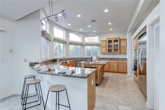 a kitchen with granite countertop lots of counter top space and stainless steel appliances