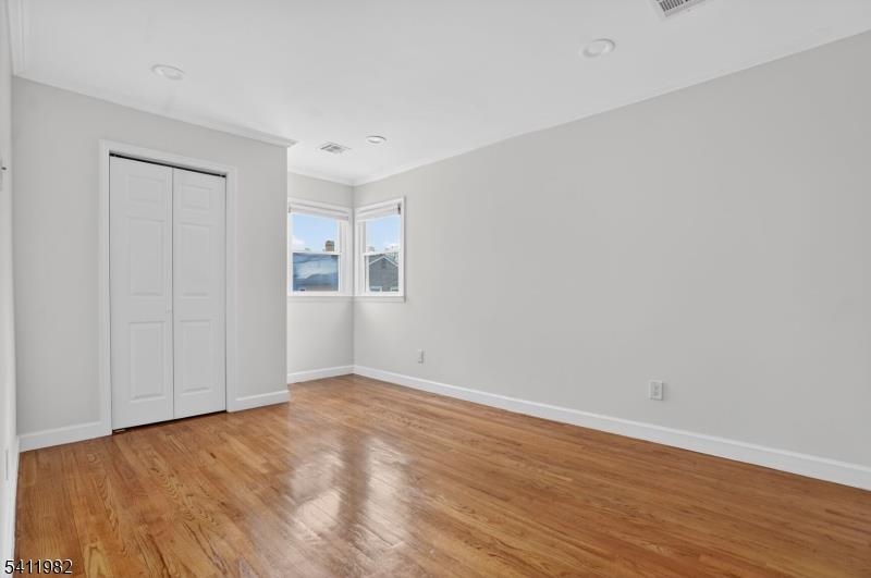 16 George Street, Unit 2 Bayonne, NJ 07002 - Photo 5 of 10 a view of an empty room with wooden floor