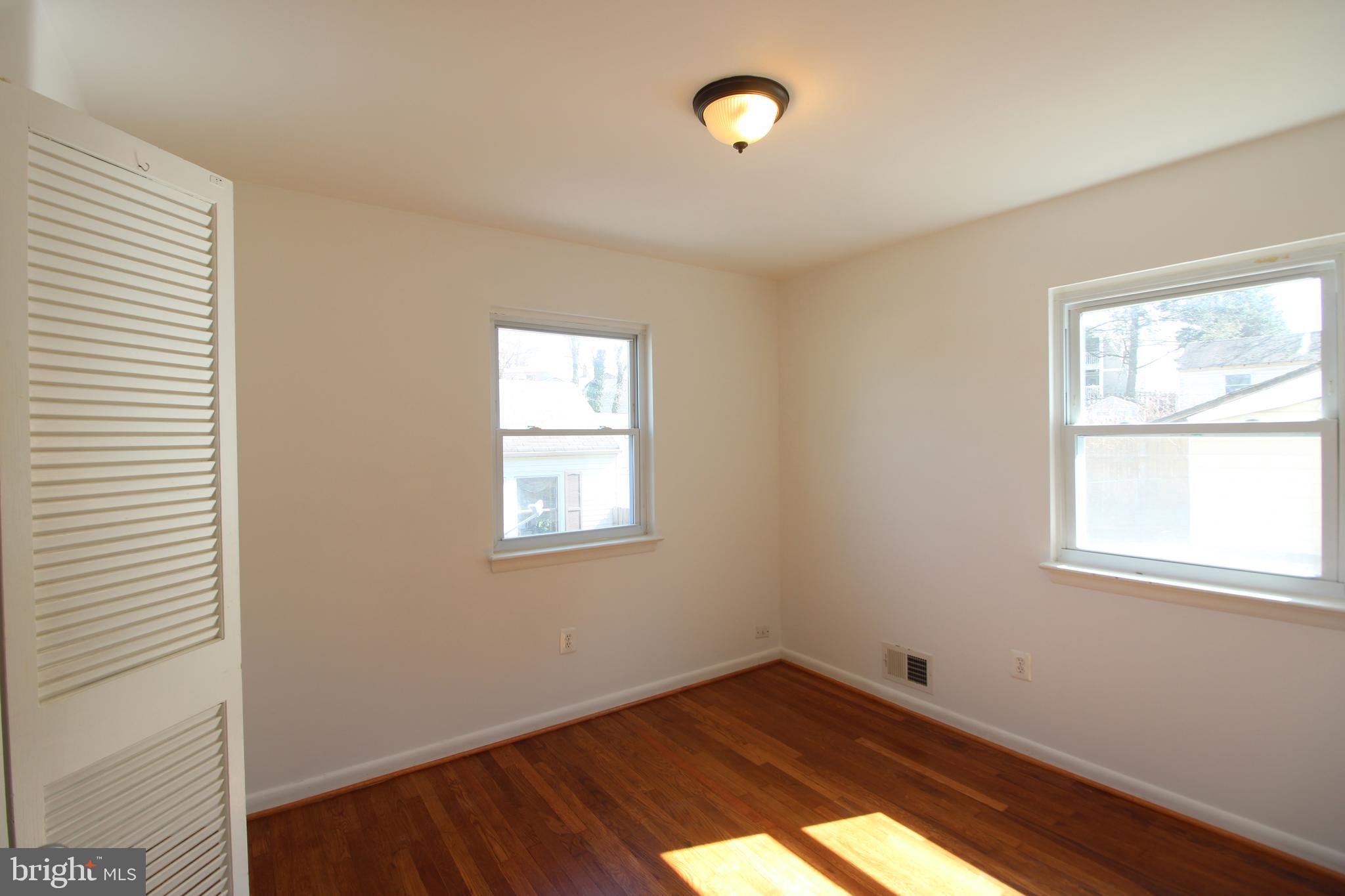 4416 Randolph Road Silver Spring, MD 20906 - Photo 11 of 27 an empty room with wooden floor and windows
