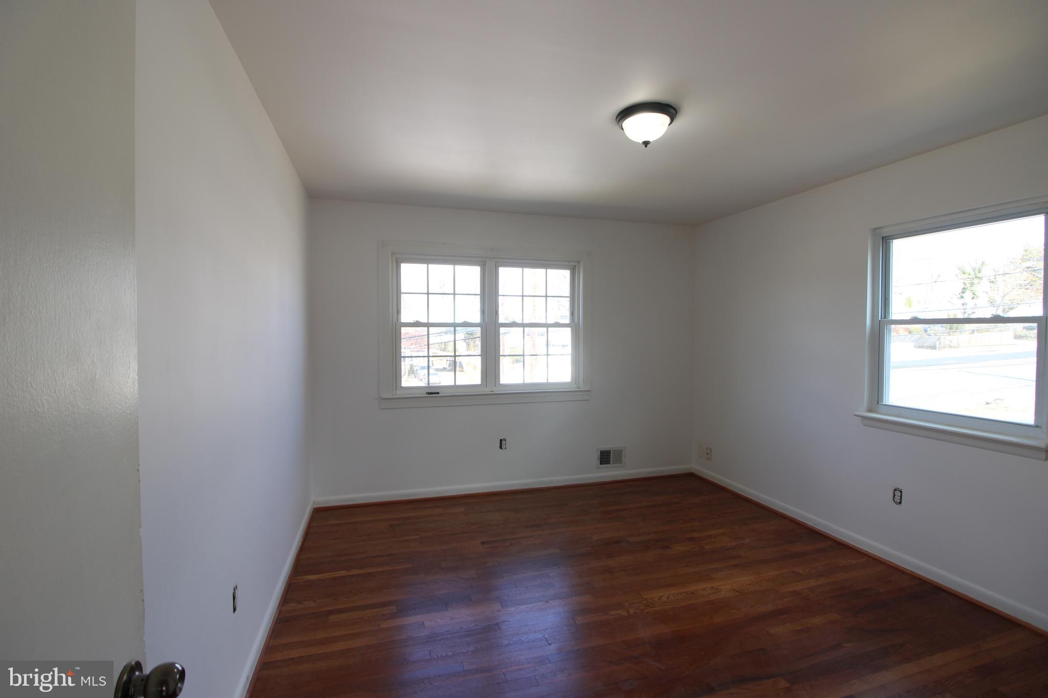 4416 Randolph Road Silver Spring, MD 20906 - Photo 13 of 27 an empty room with wooden floor and windows
