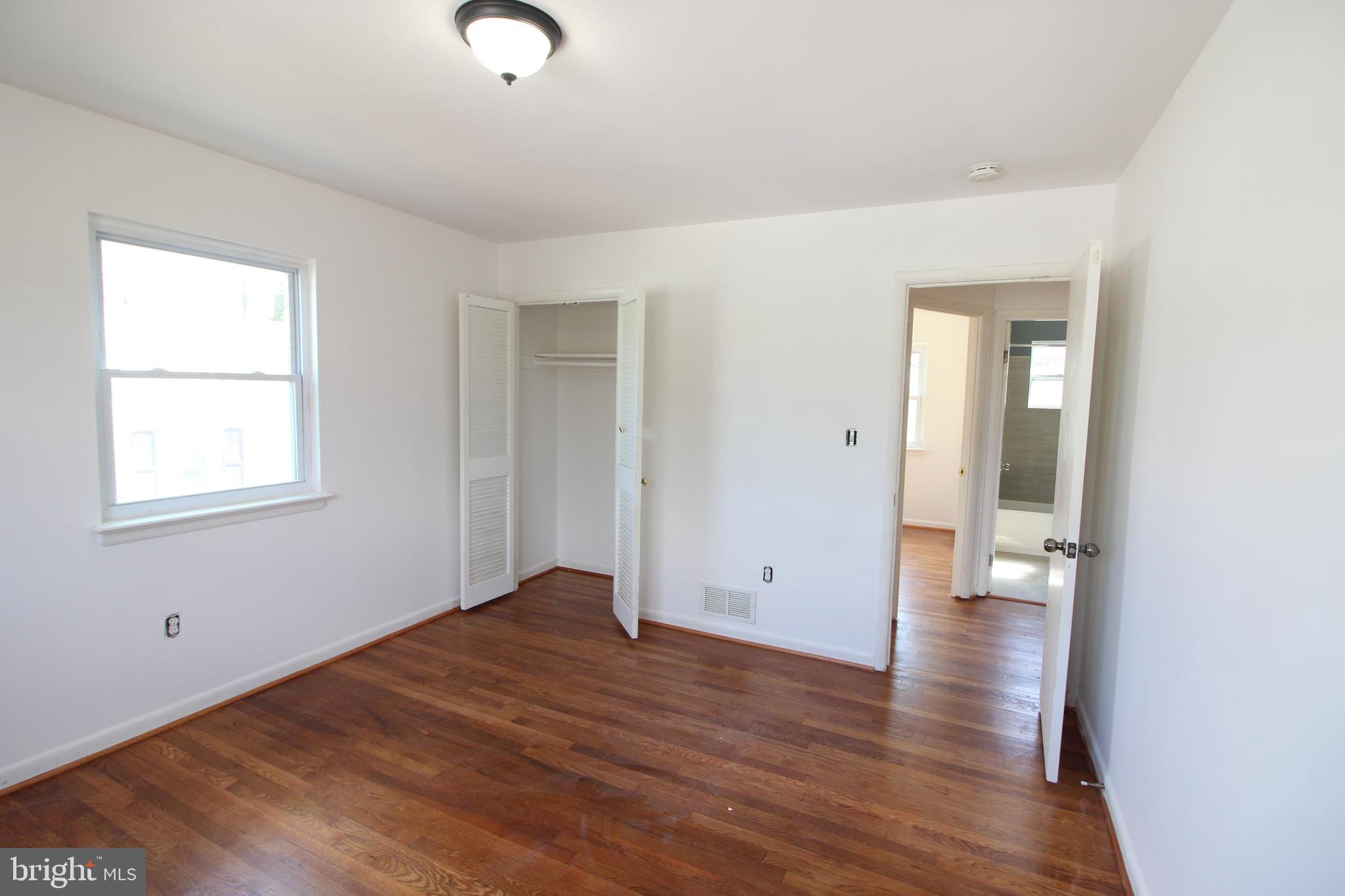 4416 Randolph Road Silver Spring, MD 20906 - Photo 14 of 27 a view of an empty room with wooden floor and a window