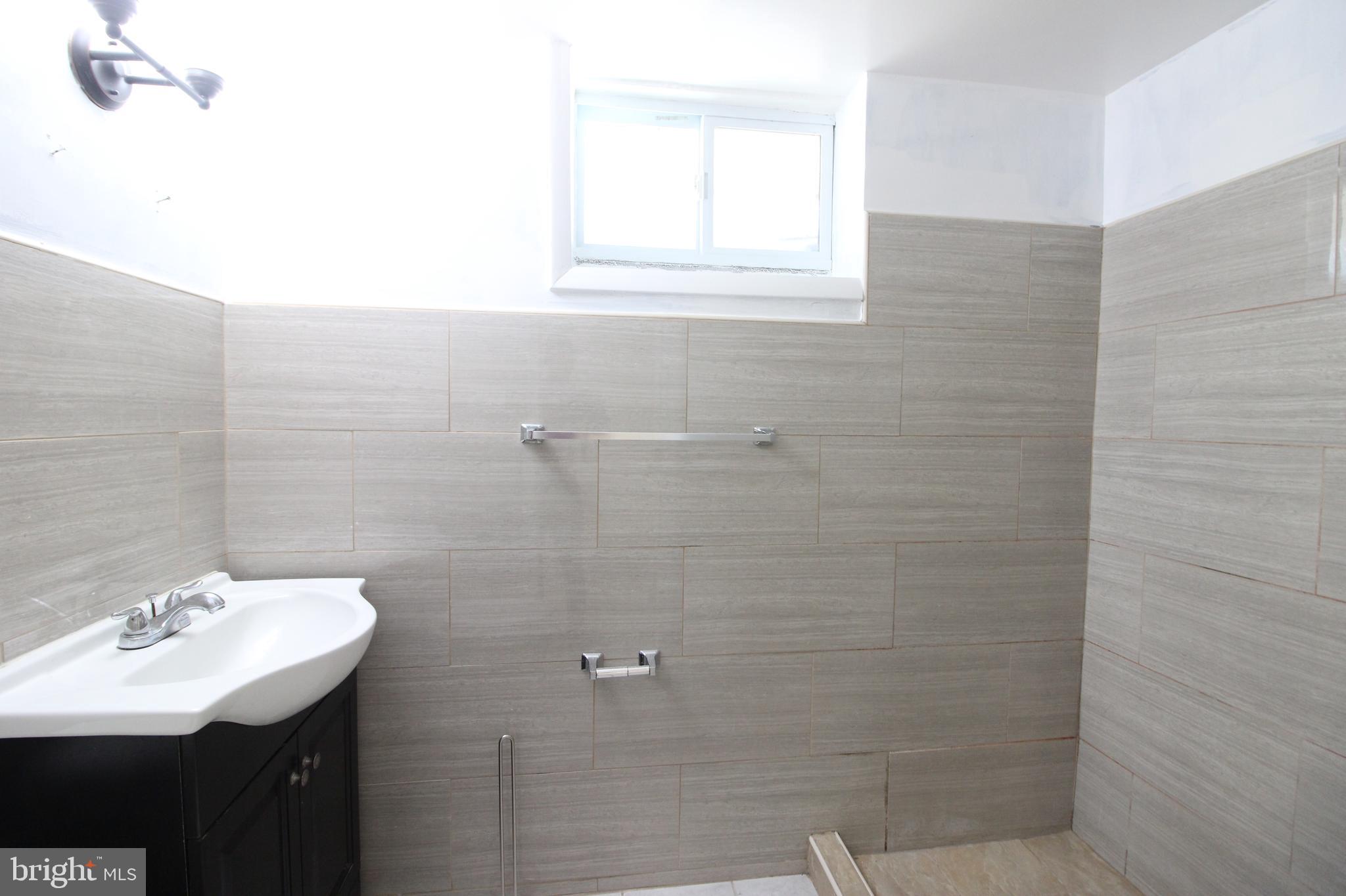 4416 Randolph Road Silver Spring, MD 20906 - Photo 21 of 27 a bathroom with a sink a mirror and a shower