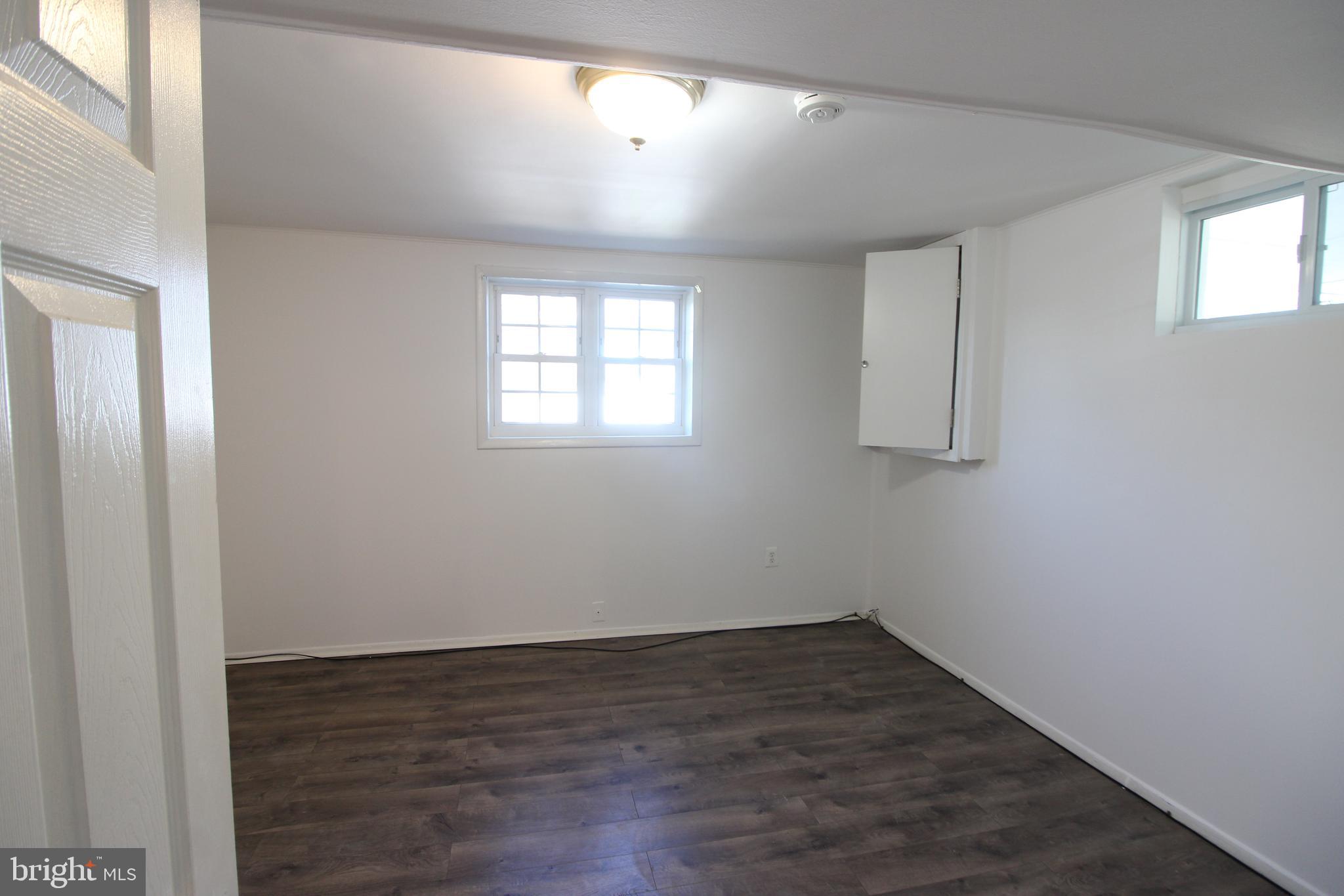 4416 Randolph Road Silver Spring, MD 20906 - Photo 24 of 27 an empty room with wooden floor and windows