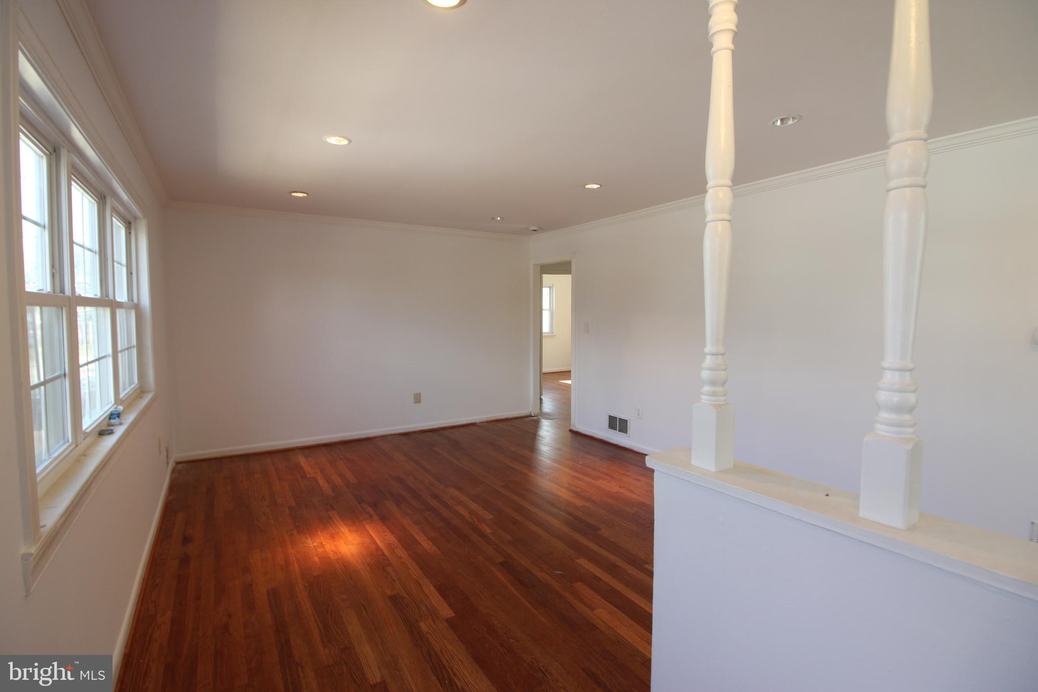 4416 Randolph Road Silver Spring, MD 20906 - Photo 3 of 27 an empty room with wooden floor and windows
