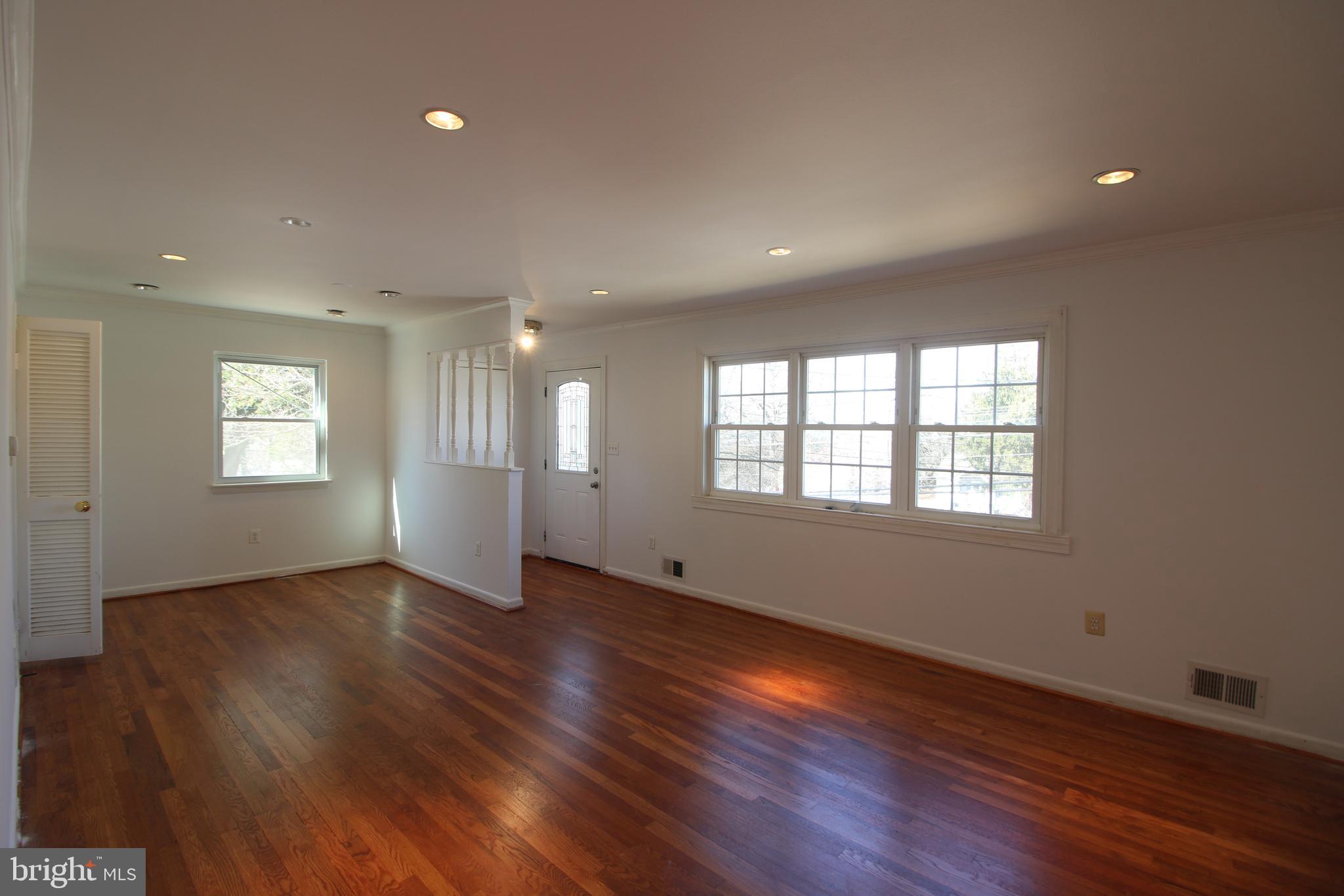 4416 Randolph Road Silver Spring, MD 20906 - Photo 5 of 27 a view of an empty room with wooden floor and a window