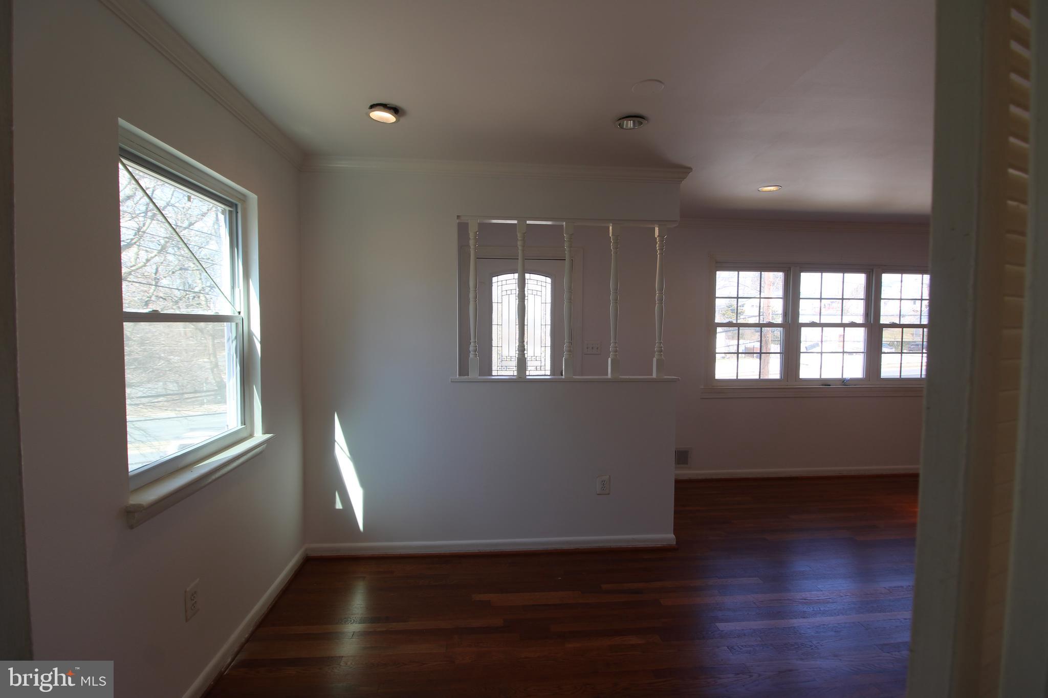 4416 Randolph Road Silver Spring, MD 20906 - Photo 6 of 27 an empty room with wooden floor and windows