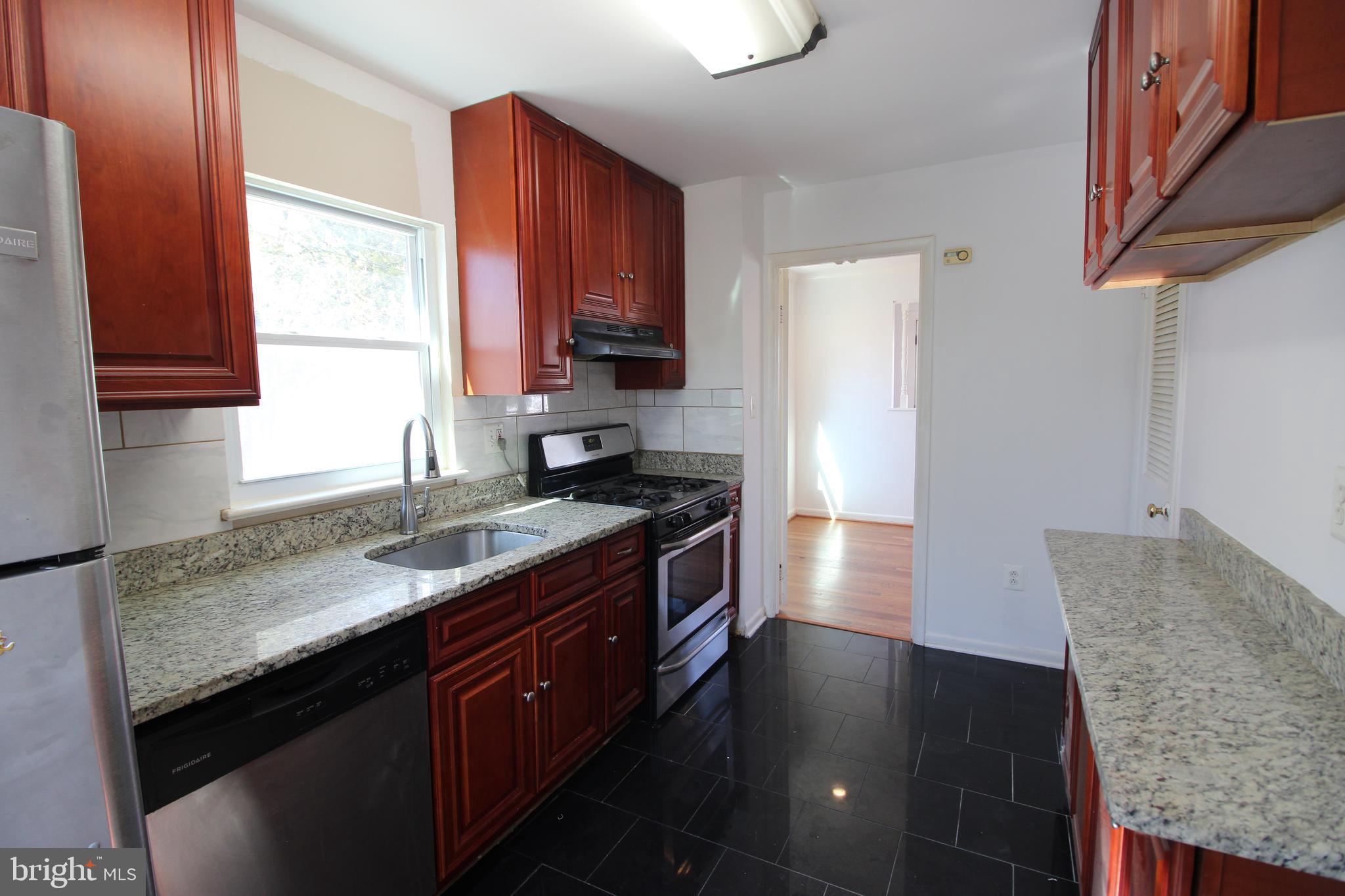 4416 Randolph Road Silver Spring, MD 20906 - Photo 7 of 27 a kitchen with stainless steel appliances granite countertop a sink stove and cabinets