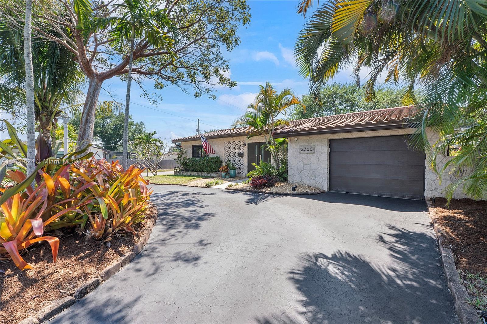 3700 West Park Road Hollywood, FL 33021 - Photo 1 of 45 a front view of a house with a yard and garage