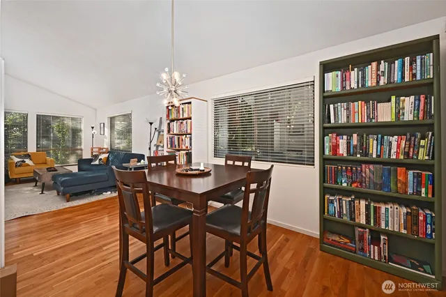 a view of a dining room with furniture and a bookshelf