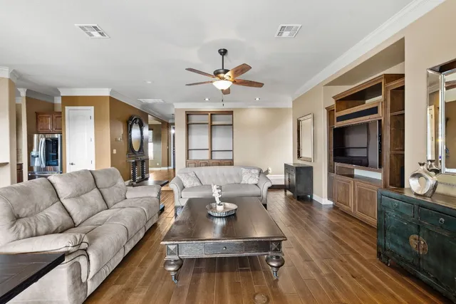 an aerial view of a house with a big yard plants and large trees