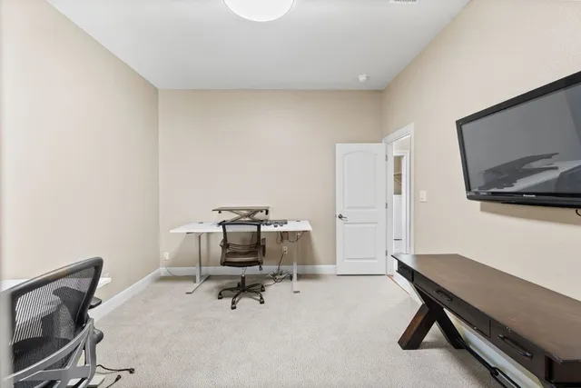 a large bedroom with a bed and a window