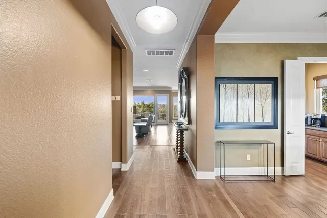 a kitchen with stainless steel appliances granite countertop a sink a stove and a wooden floors