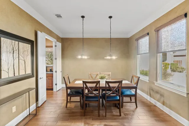 a kitchen with stainless steel appliances granite countertop a sink a stove and a wooden floors