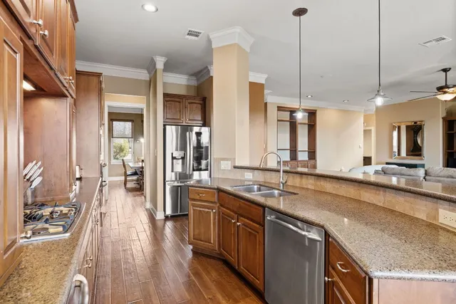 a kitchen with granite countertop a stove and cabinets