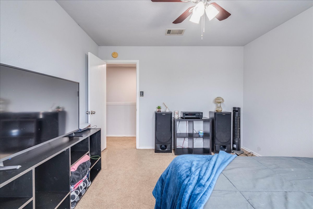 148 Buttercup Way Kyle, TX 78640 - Photo 19 of 33 Bedroom featuring light colored carpet and ceiling fan