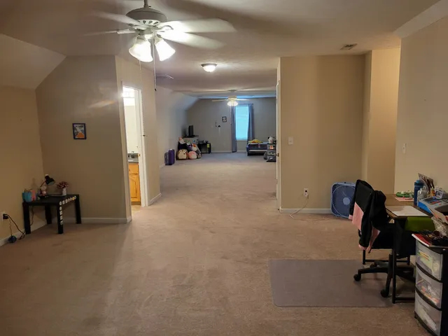 a view of a livingroom with a furniture and a ceiling fan