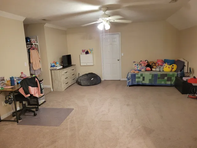 a living room with furniture and a gym machine