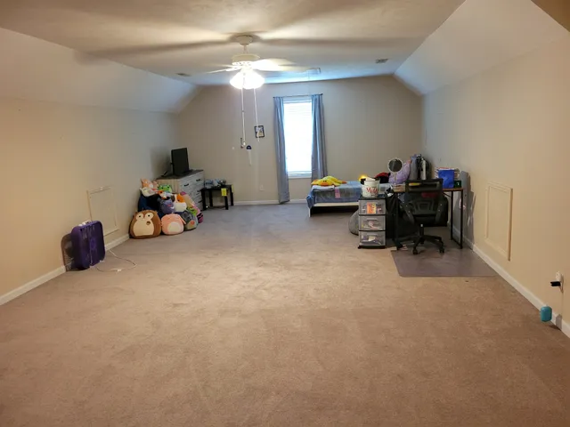 a view of a room with gym equipment and a large window