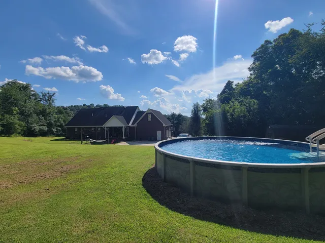 a view of a swimming pool with an outdoor space and seating area