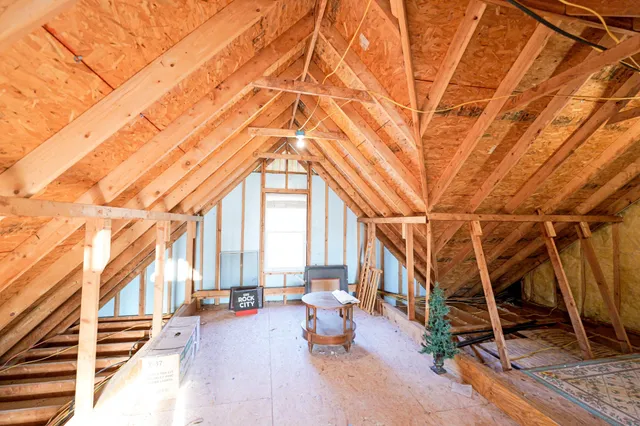 a view of a patio with table and chairs and wooden fence