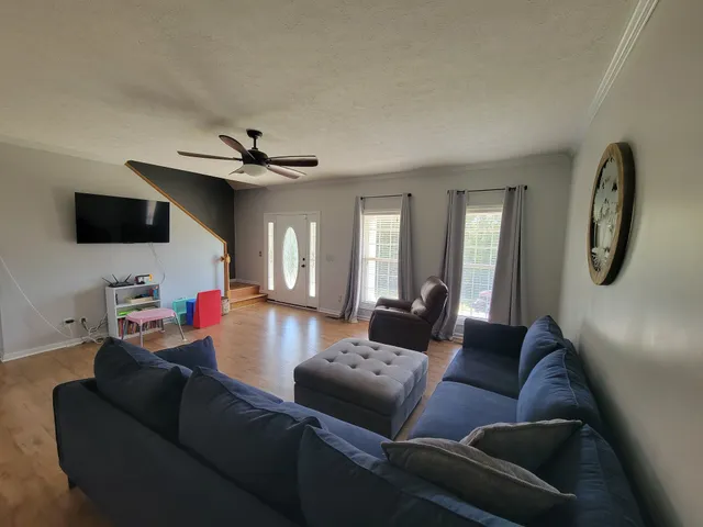 a living room with furniture and a flat screen tv
