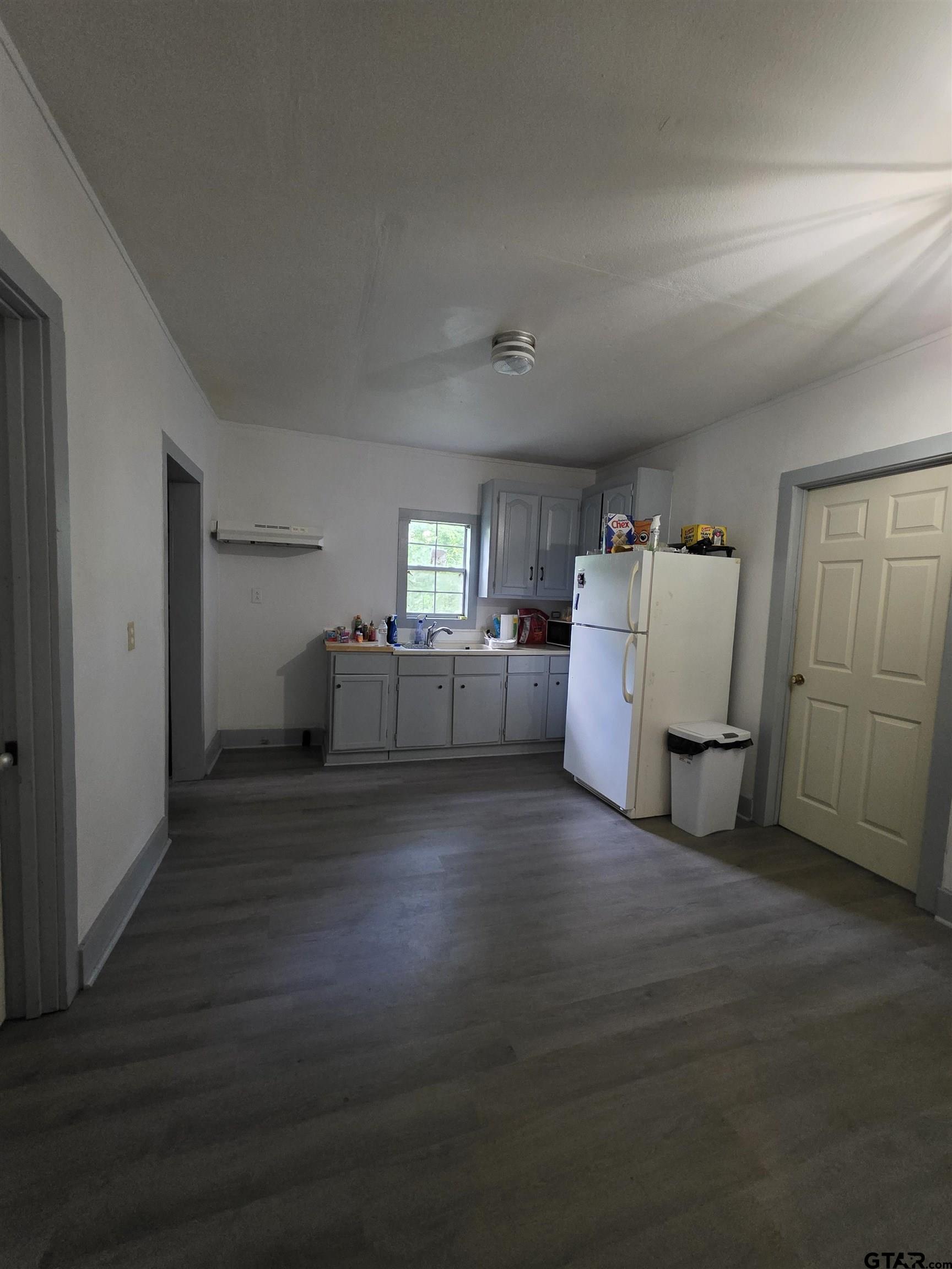 316 North Hospital Street Rusk, TX 75785 - Photo 12 of 21 a view of a kitchen with furniture and wooden floor