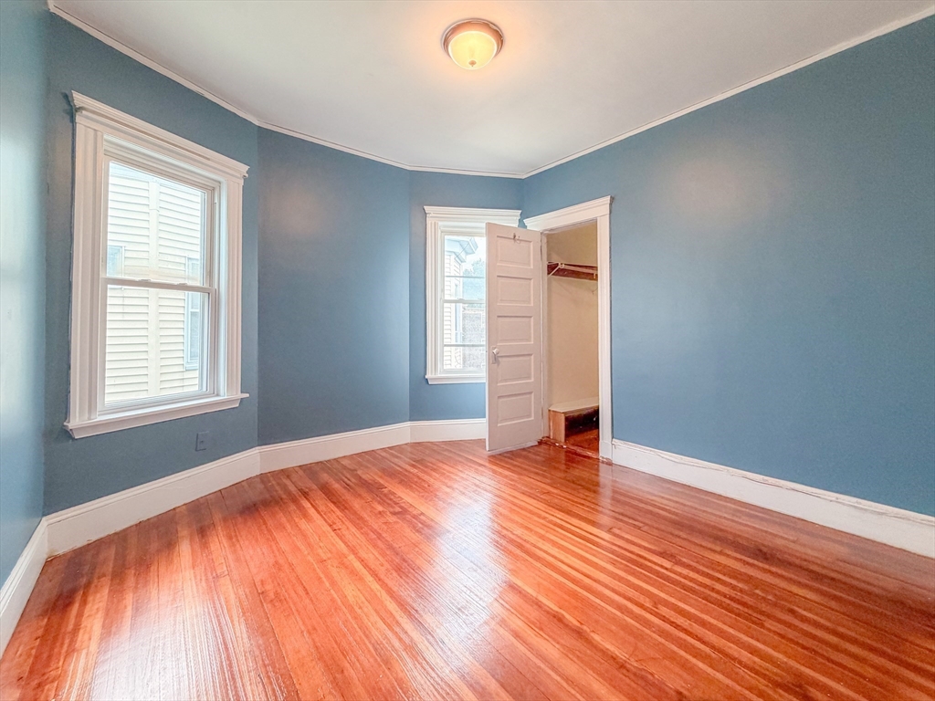 21 St Marks Road Boston, MA 02124 - Photo 19 of 30 an empty room with wooden floor and windows