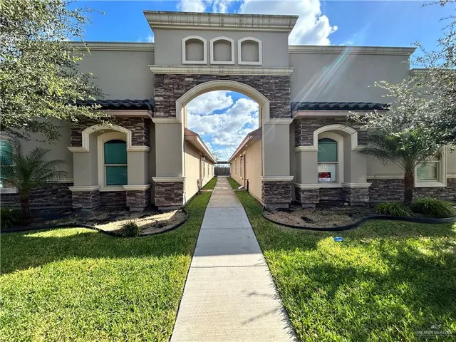 a front view of a house with garden