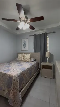 a bedroom with a bed and a ceiling fan