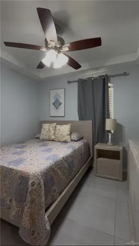 a bedroom with a bed and a ceiling fan