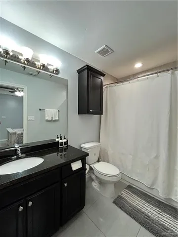 a bathroom with a double vanity sink toilet and a mirror