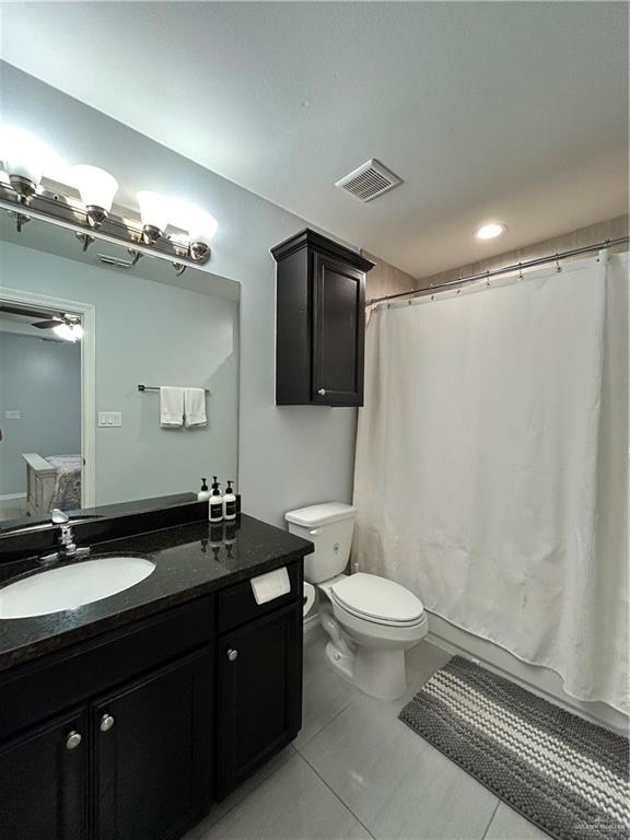 4710 North Ebony Street Pharr, TX 78577 - Photo 5 of 12 a bathroom with a double vanity sink toilet and a mirror