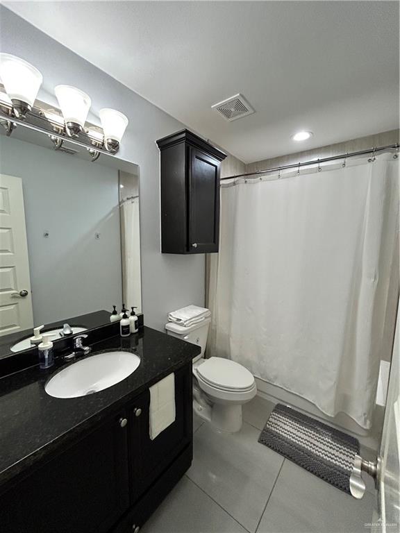 4710 North Ebony Street Pharr, TX 78577 - Photo 10 of 12 a bathroom with a sink a toilet a mirror and shower