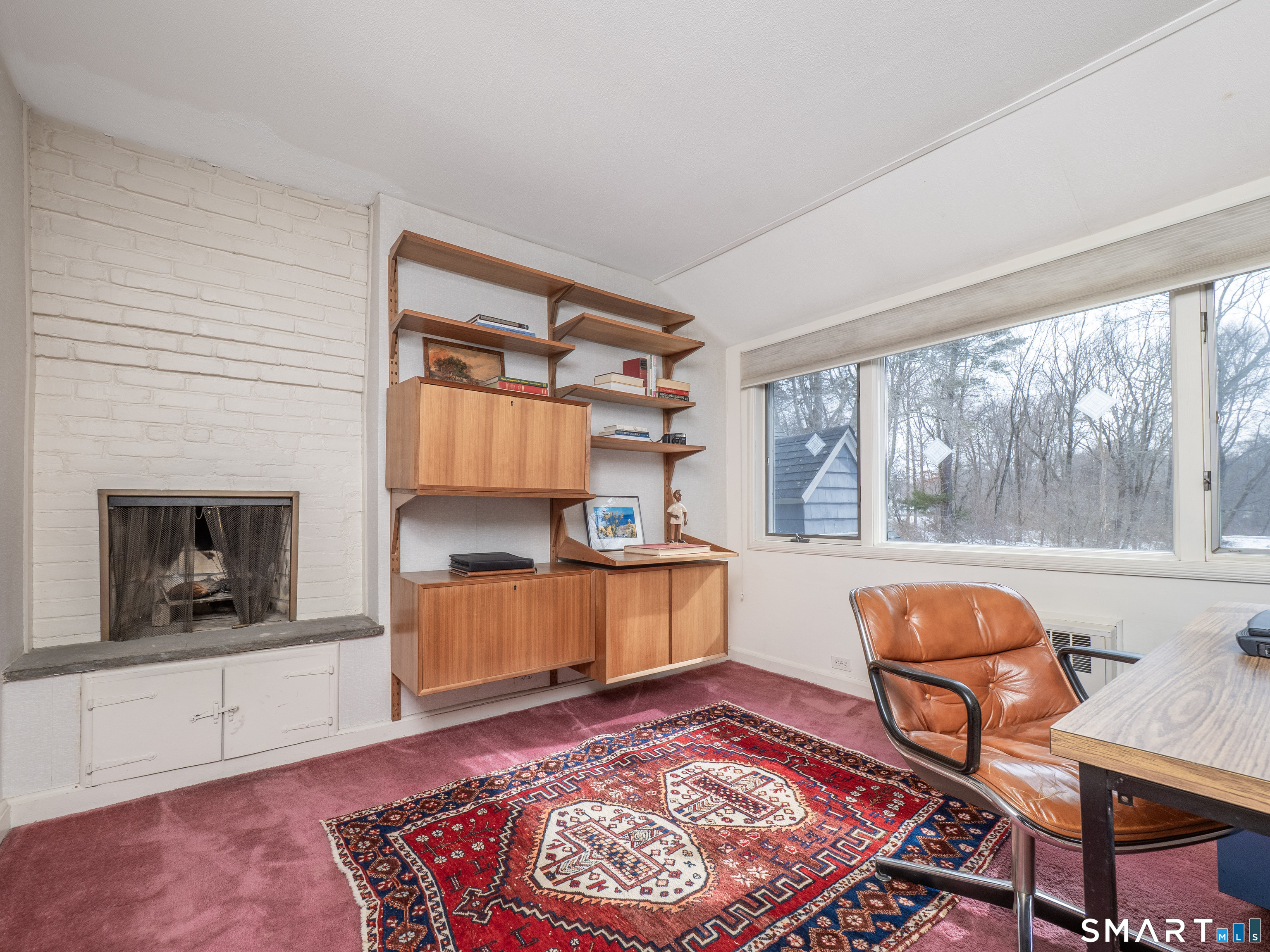 340 Sturges Ridge Road Wilton, CT 06897 - Photo 24 of 40 a living room with furniture and a fireplace