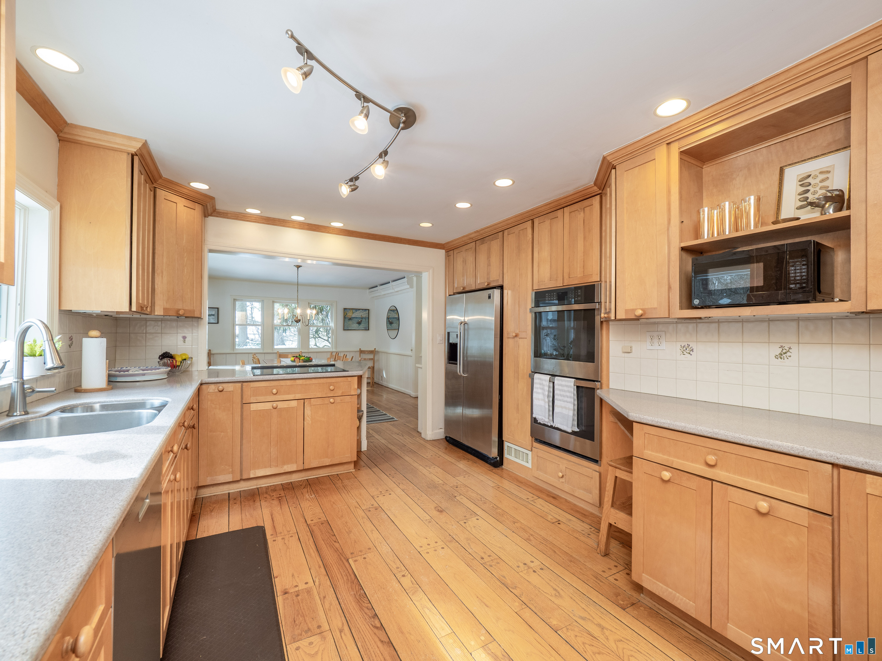 340 Sturges Ridge Road Wilton, CT 06897 - Photo 8 of 40 a large kitchen with stainless steel appliances granite countertop a large stove top oven a refrigerator a sink and dishwasher with wooden floor