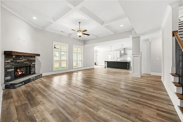 a view of a room with wooden floor and window