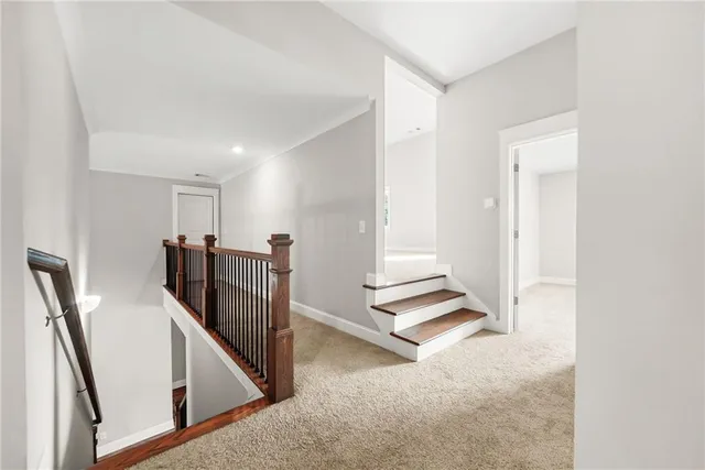 a spacious bedroom with a bed couch and view of living room