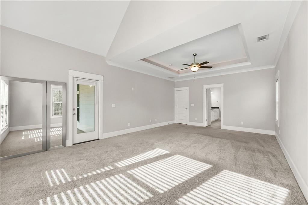 2519 Hog Liver Road Carrollton, GA 30117 - Photo 16 of 39 a view of a livingroom with wooden floor and a ceiling fan