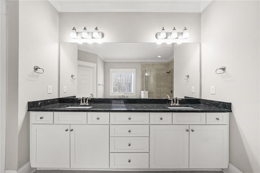 2519 Hog Liver Road Carrollton, GA 30117 - Photo 18 of 39 a bath room with granite countertop two sink and mirror